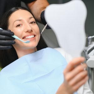 Doctor examining patient's teeth, closeup. Cosmetic dentistry